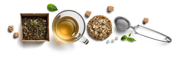 Green tea with natural aromatic additives and accessories. Top view on white background