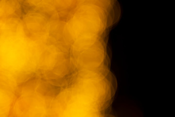 Defocused of blurred golden bokeh circle light from lighting bulb Merry Christmas and Happy New Year decorative in the night for abstract background texture