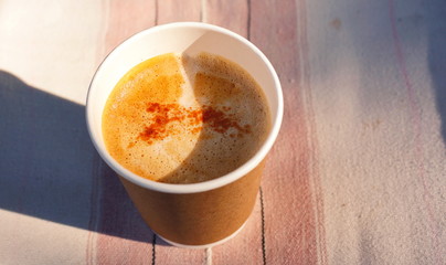 Hot coffee on a wooden background