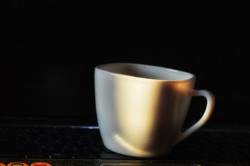 A white coffee cup on the top lab