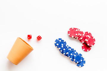 Poker concept. Chips, dices, cup for dice on white background top-down copy space