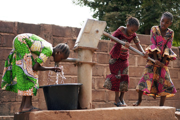 African Children At A Public Borehole Fetching Water For Their Families - obrazy, fototapety, plakaty