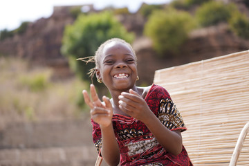 Wholeheartedly Laughing African Girl Enjoying A Joke