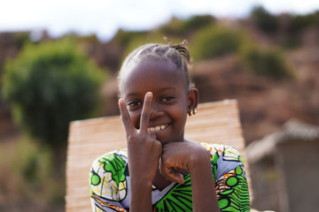 Beautiful African Girl With a Big Smile Making The Peace Sign