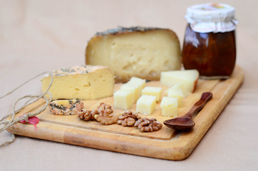 Two types of sheep cheese cut into cubes displayed on a cutting board