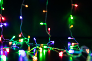 Obraz premium Christmas burning garlands lying on the table