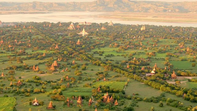 Flying over an amazing landscape of hundreds of Buddhist monuments and temples in Bagan, Myanmar.