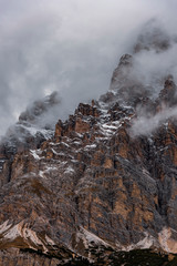 Close-up Dolomite peaks in Alps-Italy , South Tyrol - Foggy winter day with low clouds surrounding mountains - High ISO image