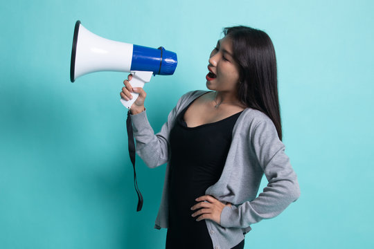 Beautiful young Asian woman announce with megaphone.