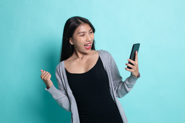 Successful young Asian woman with mobile phone.