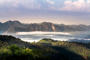 Fototapeta na wymiar Landscape with mountains and clouds at Monkcrubasai view point in Mae Moei National Park in Tak province, Thailand.