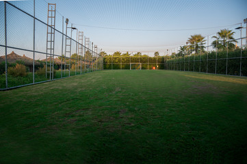 Fenced soccer fiels or handball field with lights