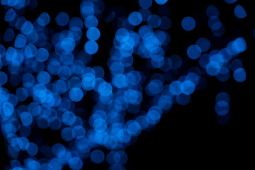 Defocused of blurred blue bokeh circle light from lighting bulb in the night for abstract background texture patterns