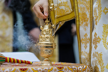 Details with a golden metallic christian orthodox frankincense burner, or censer.