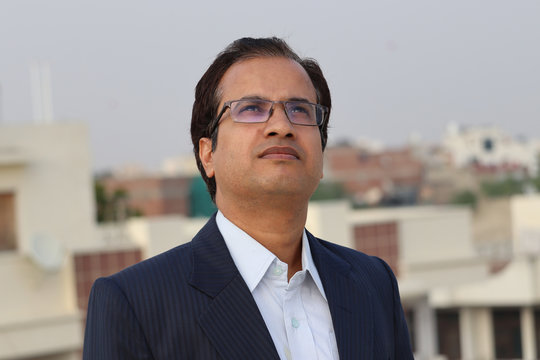 An Indian businessman thinking and posing