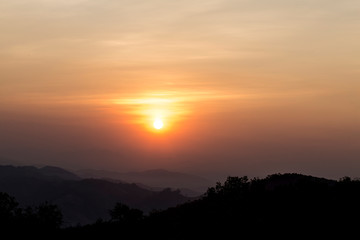 Sky and clouds at sunset over  mountains with orange and blue color