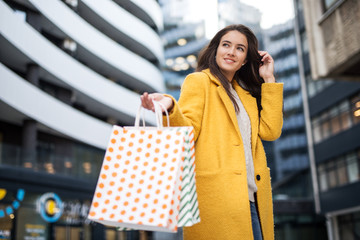 Beautiful smiling young woman with shopping bags
