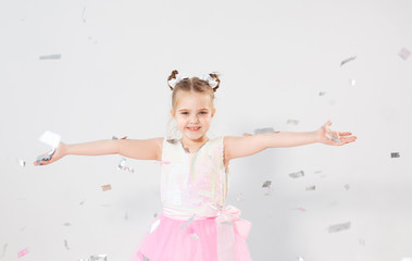 Party, holidays, birthday, new year and celebration concept - Cute child throwing confetti.