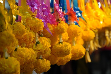 Garlands of colorful Thai flowers on the roadside