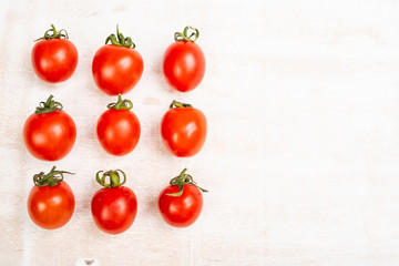 Fresh red ripe tomatoes on rustic white background