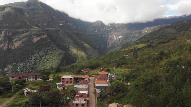 Beautiful drone shot of small village deep in the Peruvian Amazon, flying towards the Gocta falls