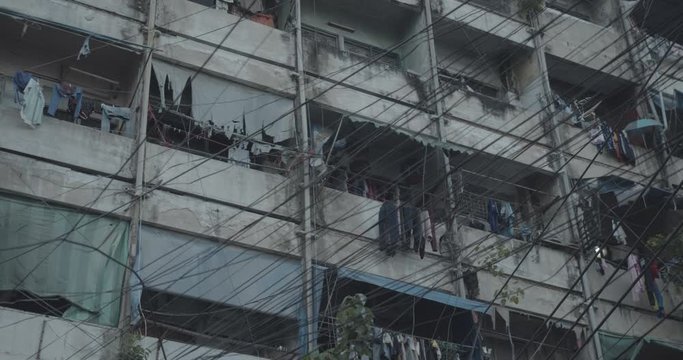 Bangkok chinatown block of flats closeup - People living in dirty apartment house in downtown city - Ghetto Thailand - Asian living - Exterior