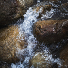 Water flowing through boulders in a stream