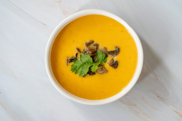 Homemade Thai Sweet Potato Soup with Cilantro, Coconut Milk Cream, Lime and Mushrooms.