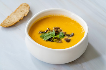 Homemade Thai Sweet Potato Soup with Cilantro, Coconut Milk Cream, Lime and Mushrooms.