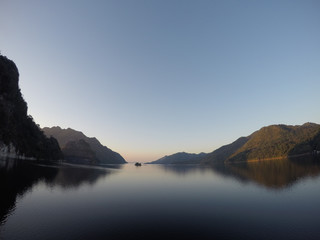 Natural reservoir view surrounded by mountains and surrounded forest