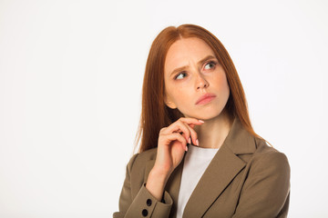 beautiful young woman with red hair in a jacket on a white background