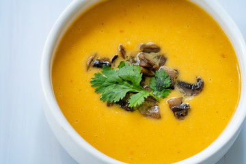 Homemade Thai Sweet Potato Soup with Cilantro, Coconut Milk Cream, Lime and Mushrooms.