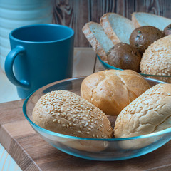 rectangular loaf of wheat bread with a baked shiny crust on the kitchen table.