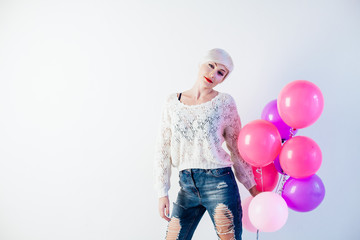 blonde woman with balloons and gift for holiday