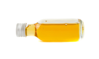CBD Oil in glass of bottle on white background.