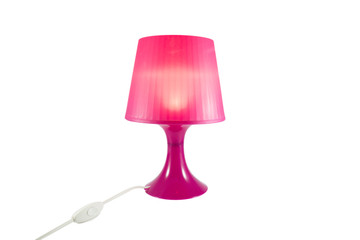 Isolated pink plastic lamp on white background for home decoration.