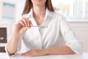 Speech therapist with logopedic probe in clinic, closeup