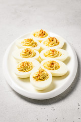 Classic devilled eggs with mustard and smoked paprika. Selective focus, copy space.