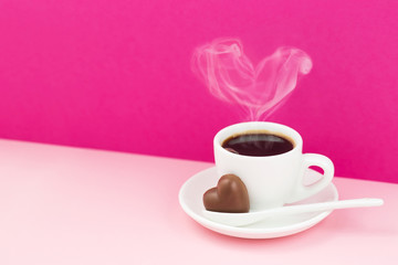 Obraz na płótnie Canvas Valentine' s day greeting card. Cup of coffee and chocolate heart on a pink background