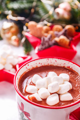 Hot chocolate with marshmallow and cookies in Xmas setting background. Concept of Christmas holiday. Warm tone. Vertical