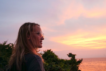 The close up of the girl's face with the ocean behind