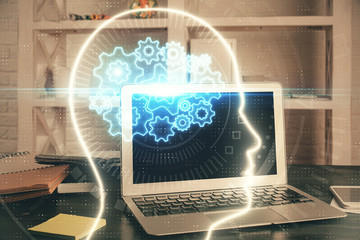 Double exposure of work table with computer and brain sketch hologram. Brainstorming concept.