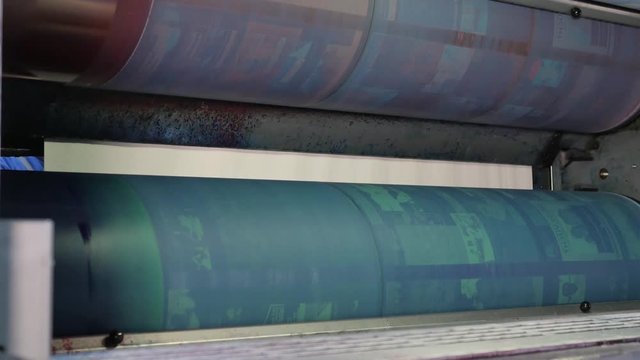 Installing new printing plates at the ink rollers of press machine