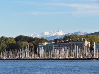 Geneva, Switzerland - October 18th 2019: a Beautiful autumn day in Lake Leman in Geneva. The Lake is surrounded by beautiful mountain that makes the sailing even more spectacular for the many sailors