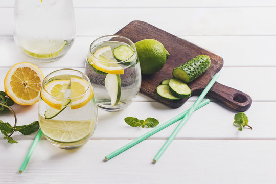 Water infused with mint, lemon and cucucmber on the white wooden table