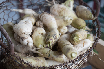 close up view of an old sort of organic carrot in a steel basket