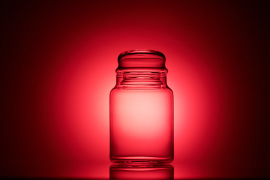 Empty Glass Jar On A Red And Black Background