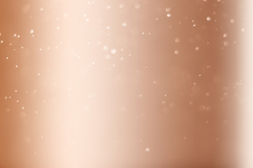 Abstract bokeh light sparkle on pink gold background