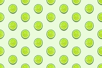 Lime slices seamless pattern on pastel green background. Minimal summer concept. Flat lay, trendy juicy color.