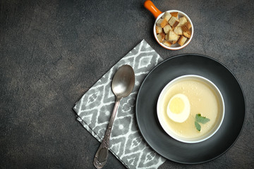 Hearty lunch. Meat broth or bouillon  from veal with breadcrumbs on a dark background. Top view. Copy space.